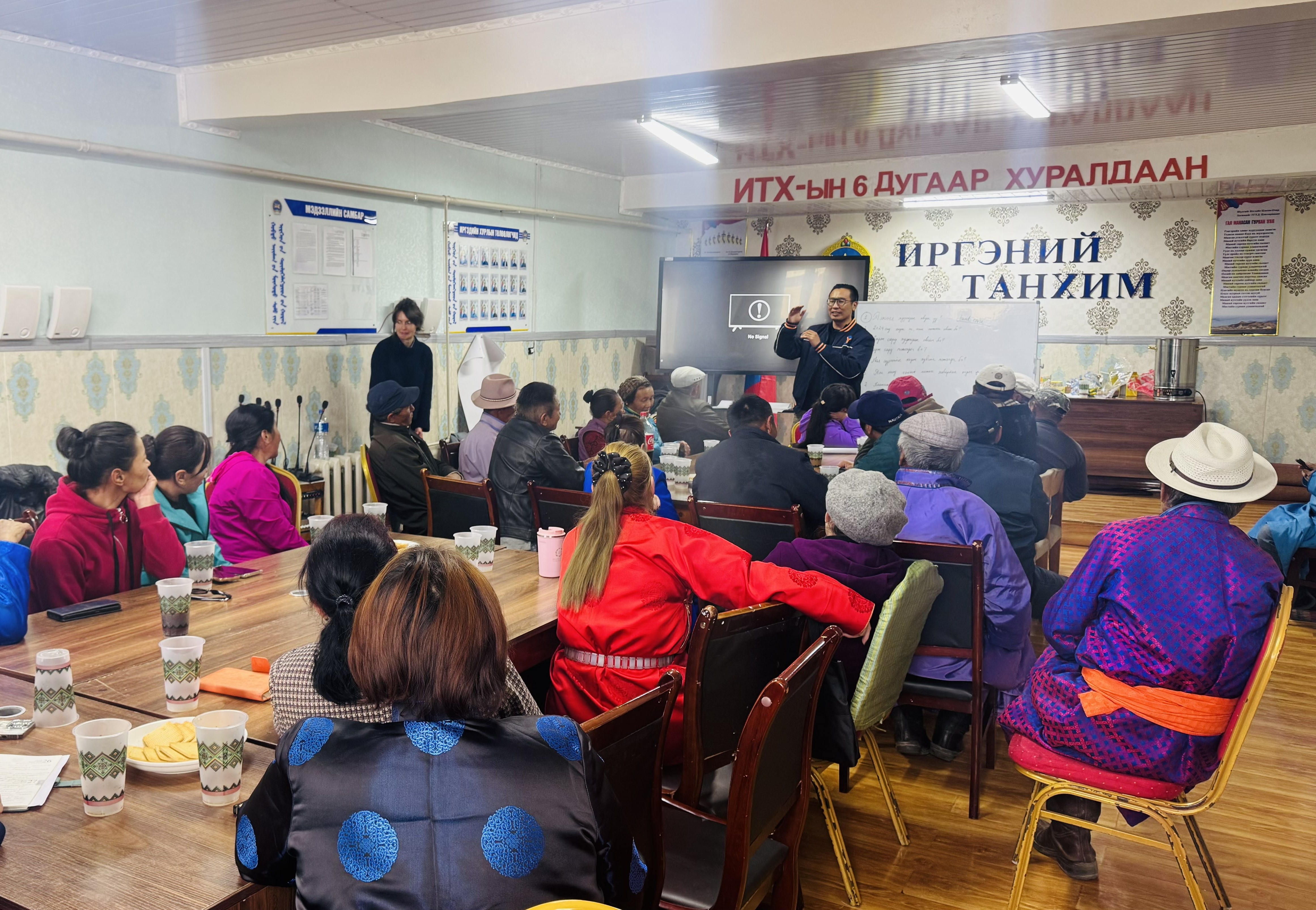 A classroom of adults in bright jackets