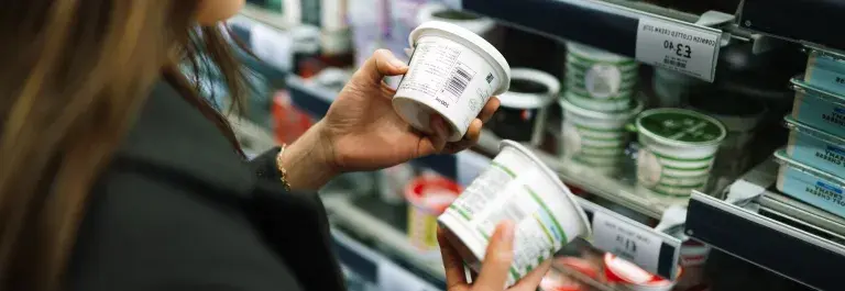 Woman looking at food product in supermarket
