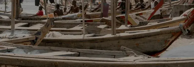 Wooden boats lined up on sea shore