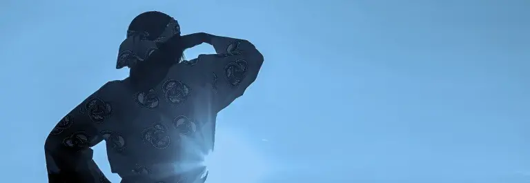 African woman in traditional clothes standing in a field of crops