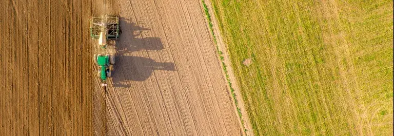 Aerial image of a tractor ploughing a field © Adobe Stock