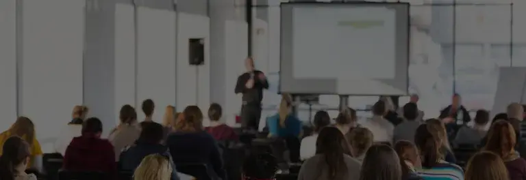People listening to speaker in a seminar or workshop