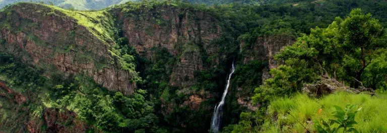 Waterfalls surrounded by lush tropical rainforest in mountainous Volta Region, Ghana