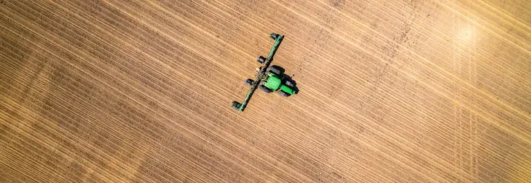 Aerial shot of a combine harvester farming &copy; Unsplash