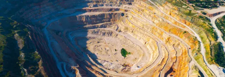 Aerial shot of a mine that has layered roads around the edges &copy; Adobe Stock