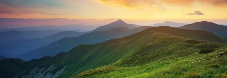 Mountain landscape with pink and orange sunset cloudy sky