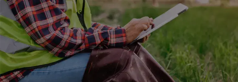Farmer woman using digital tablet computer in field