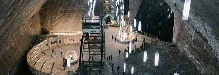 Aerial view of a dark mine with many white hanging lights © Pexels