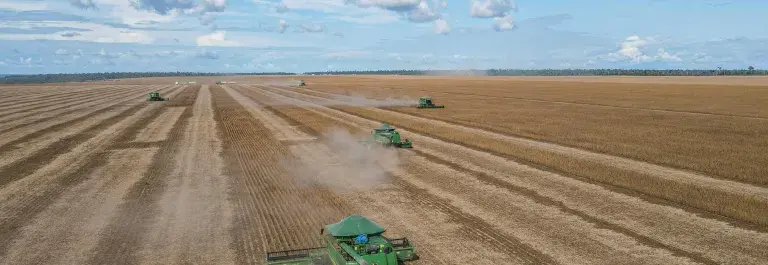 Aerial view of farming machinery harvesting soybeans in Brazil