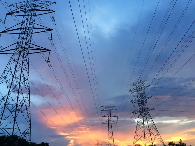 Electric pylons against a cloudy sunset sky © Pexels