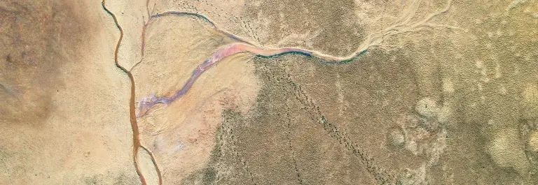 Aerial image of dry sandy landscape with small rivers © Pexels