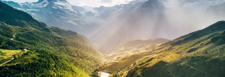 Switzerland mountain landscape with forests and sun shining © Adobe Stock