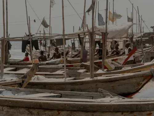 Wooden boats lined up on sea shore