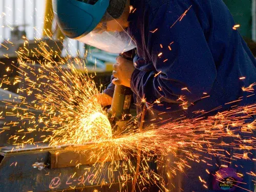 Person welding metal with bright sparks flying around &copy; Adobe Stock