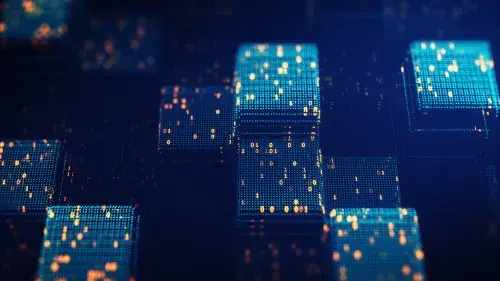 A digital rendition of light blue "blocks" of data against a dark blue background, appearing almost like the keys on a computer keyboard and formulated of ones and zeroes, some of which are highlighted in yellow and orange.