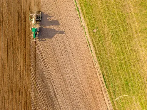 Aerial image of a tractor ploughing a field © Adobe Stock