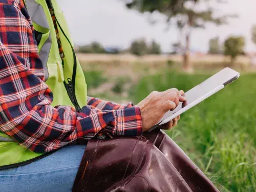 Farmer woman using digital tablet computer in agricultural field