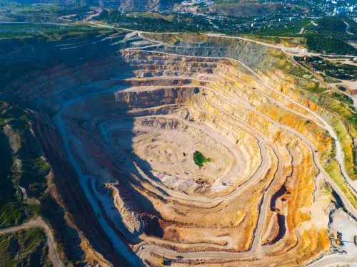 Aerial shot of a mine that has layered roads around the edges © Adobe Stock