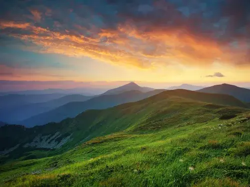 Mountain landscape with pink and orange sunset cloudy sky