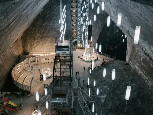 Aerial view of a dark mine with many white hanging lights © Pexels