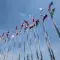 Looking up at flags of different countries against a mostly blue sky &copy; Adobe Stock