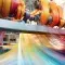 Bright colour threads going through large machinery © Adobe Stock