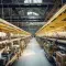 Large warehouse with lots of machinery and yellow metal frame © Adobe Stock