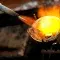 A blowtorch is heating a metal crucible, creating a jet of yellow-orange flame © Adobe Stock