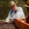 A coffee farmer shows coffee beans to customers