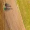 Aerial image of a tractor ploughing a field © Adobe Stock