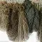 Various beige and grey hanging yarns © GoodWeave