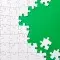 White puzzle pieces fitting together against a bright green background