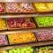 Assortment of fresh fruits on store shelves, on market counter