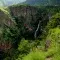 Waterfalls surrounded by lush tropical rainforest in mountainous Volta Region, Ghana
