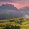 Landscape with a sunset across the mountains. ahead, you can see agricultural fields